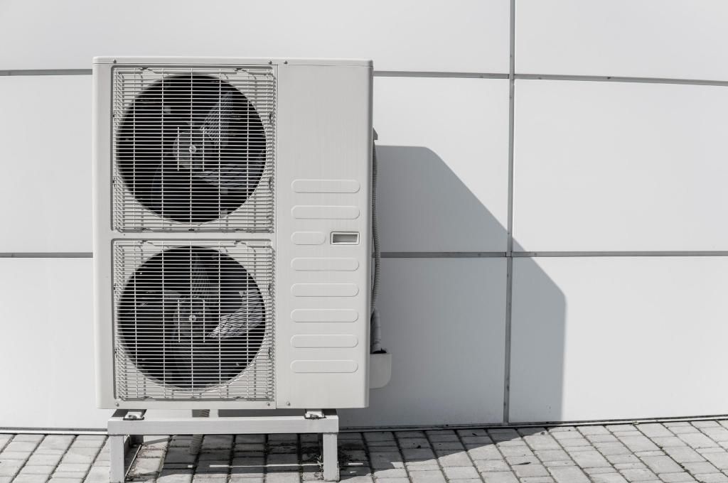 A Large Air Conditioner is Sitting on the Sidewalk in Front of a Building — Enterprise Air That's Cool in Goodwood, QLD