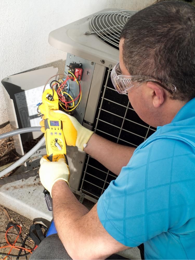 A Man in a Blue Shirt is Working on an Air Conditioner — Enterprise Air That's Cool in Mon Repos, QLD