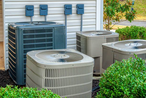 Three Air Conditioners Are Sitting Outside of a House — Enterprise Air That's Cool in Sharron, QLD