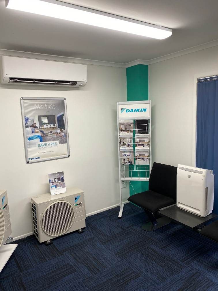 A Waiting Room With a Chair, Air Conditioner, and a Magazine Rack — Enterprise Air That's Cool in Svensson Heights, QLD