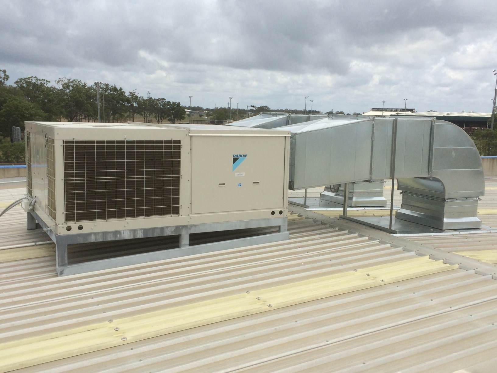 A Large Air Conditioner is Sitting on Top of a Roof — Enterprise Air That's Cool in Svensson Heights, QLD