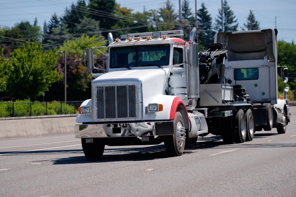 A Semi Trucks Driving Down A Highway — Castledine's Truck Painting & Repairs in Fountaindale, NSW