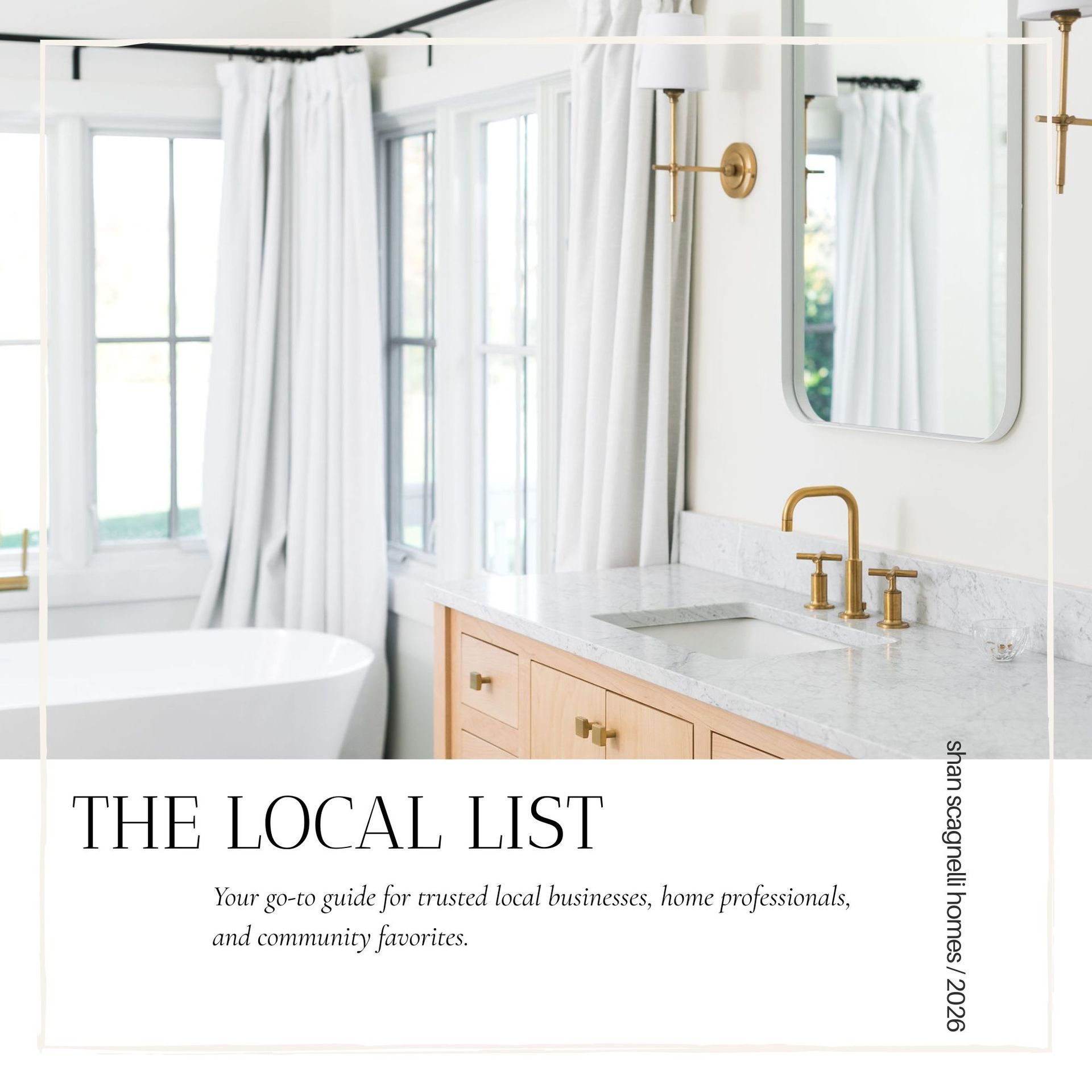 Bright white bathroom with gold fixtures, marble vanity, freestanding tub, and “THE LOCAL LIST” text overlay