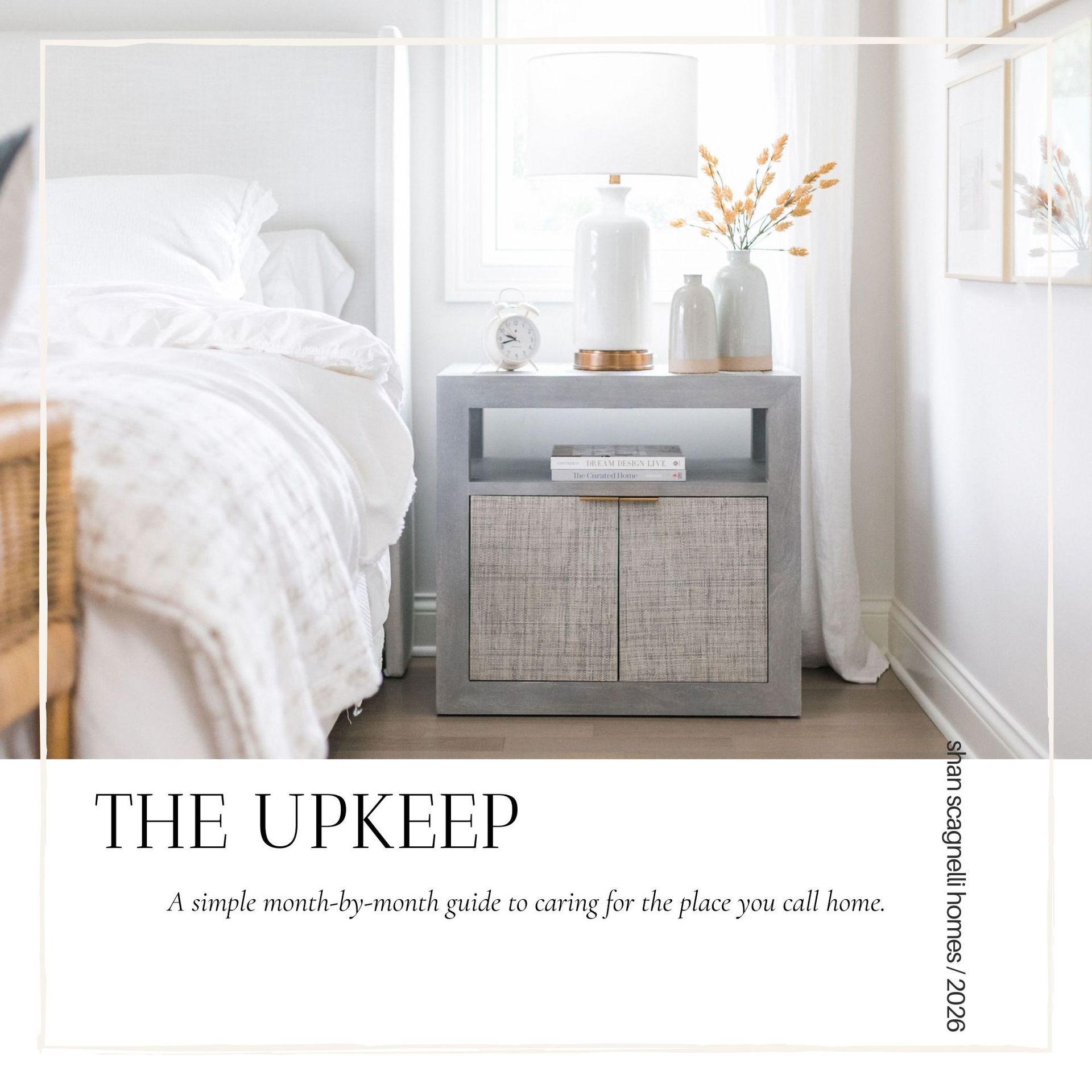 White bedroom with a gray bedside table and lamp; magazine-style text reads “THE UPKEEP.”