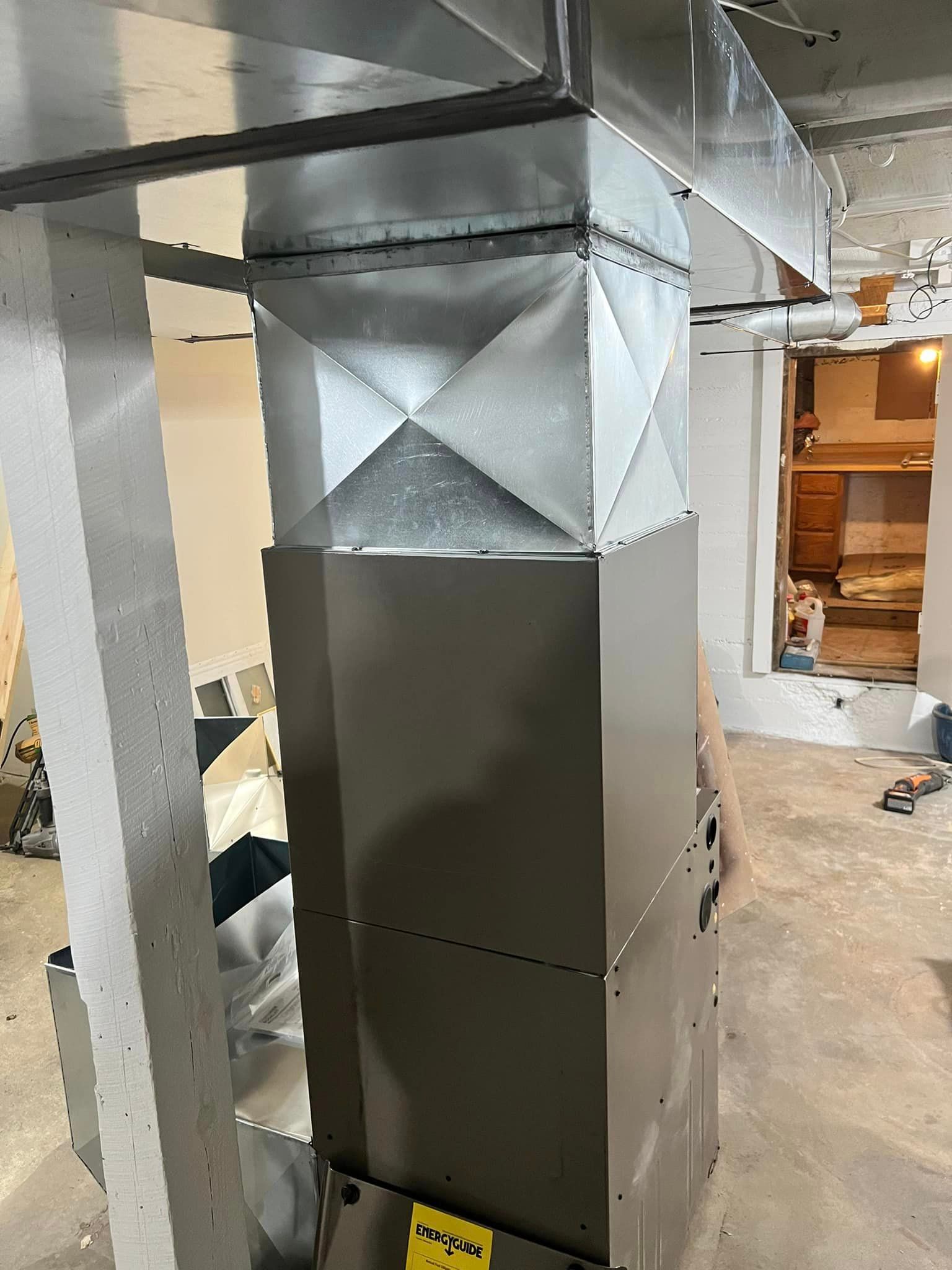 Stainless Steel Air Conditioner Being Installed in A Basement | Sullivan, MO | Williams heating and cooling