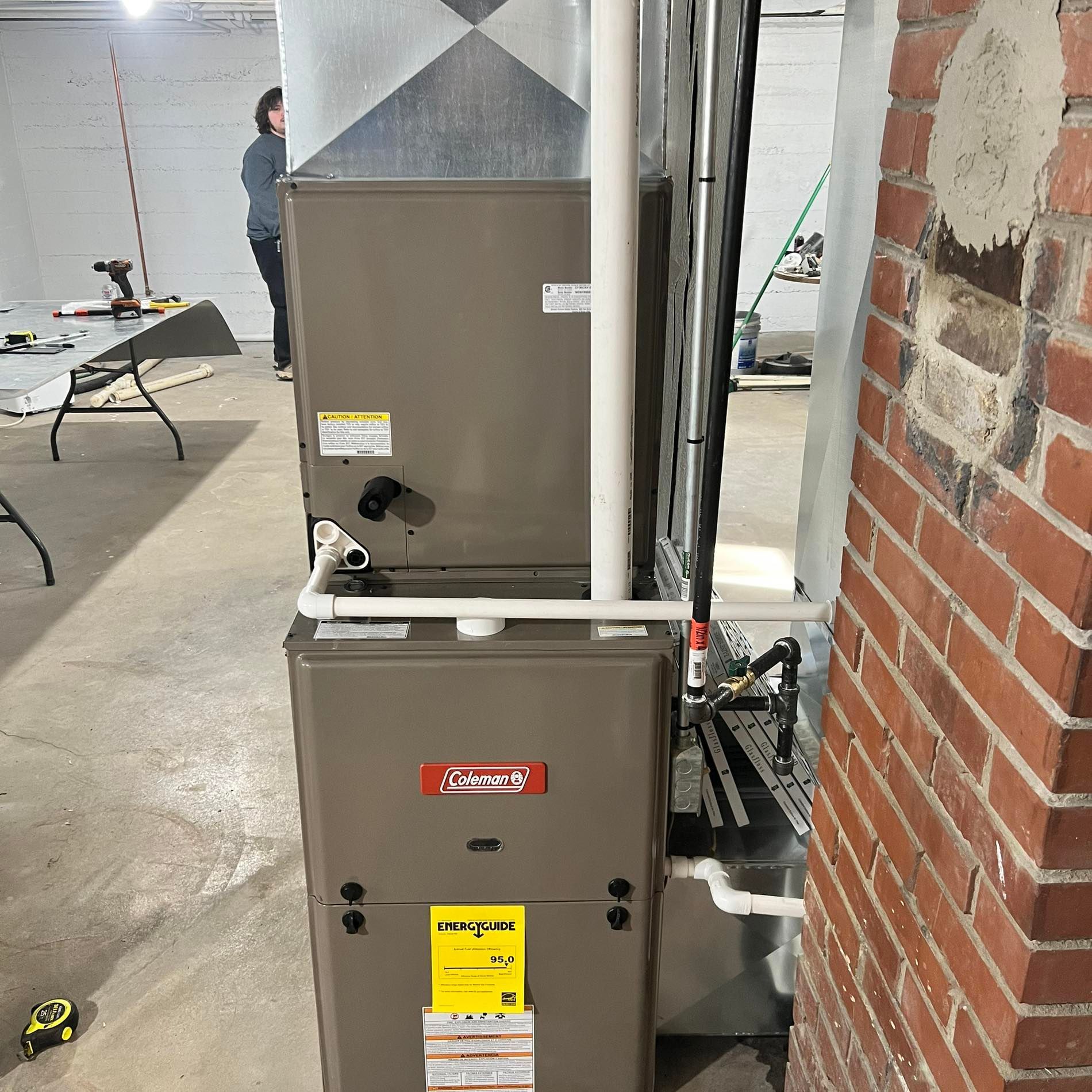 Furnace Sitting Next to A Brick Wall in A Room | Sullivan, MO | Williams heating and cooling