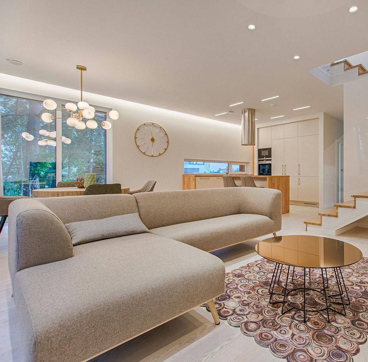 A living room with a couch and a clock on the wall