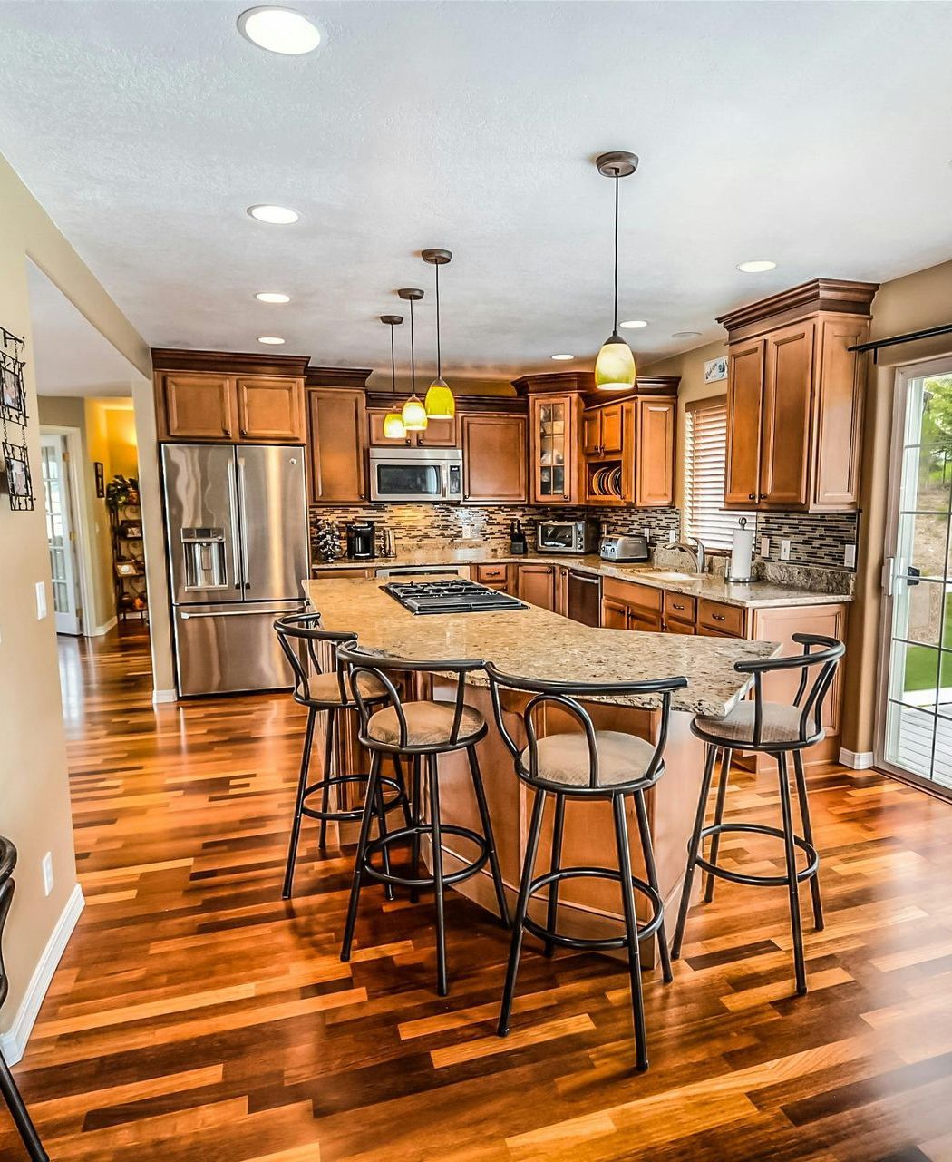 A kitchen with a large island and stools