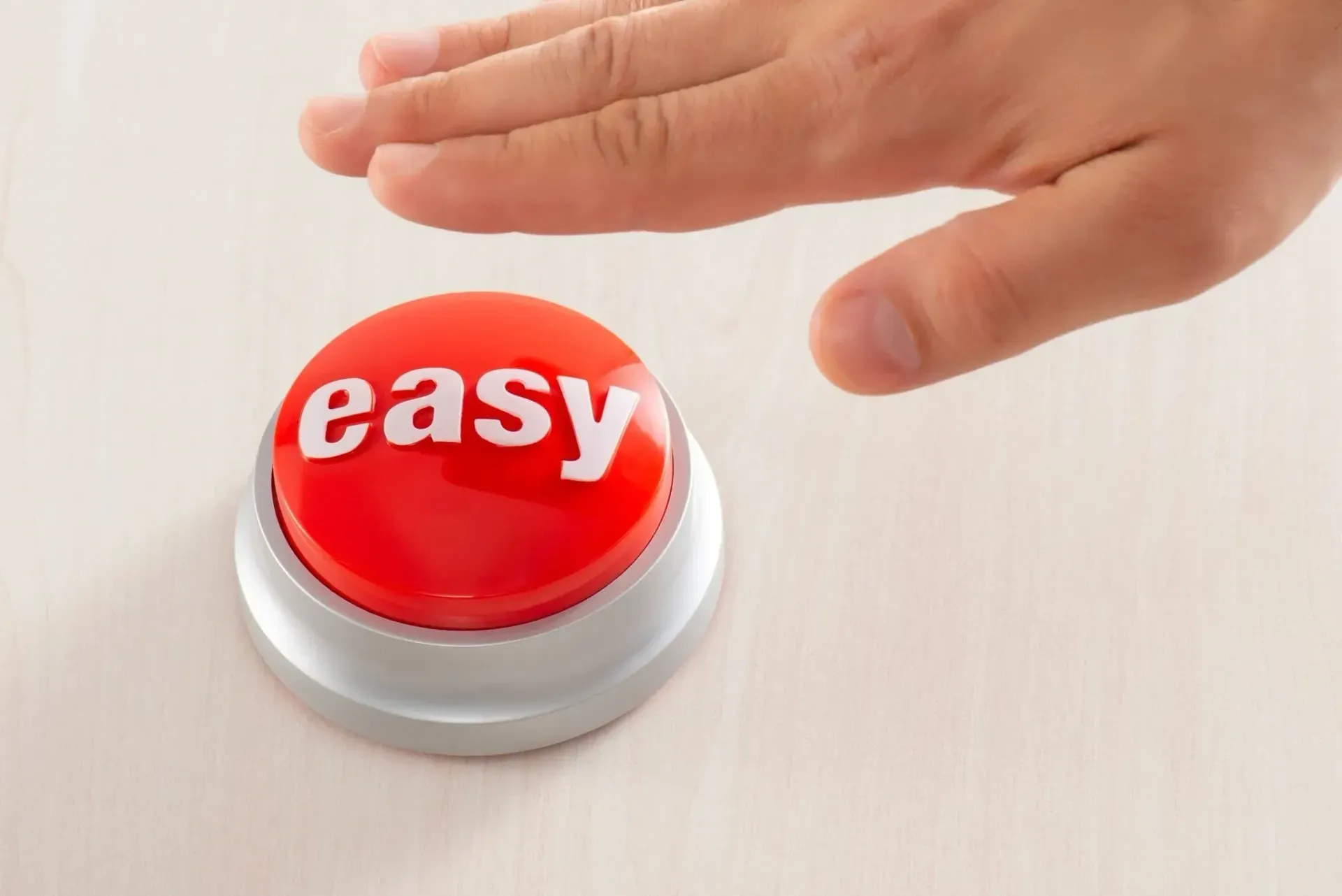 A person is pressing an easy button with their finger.
