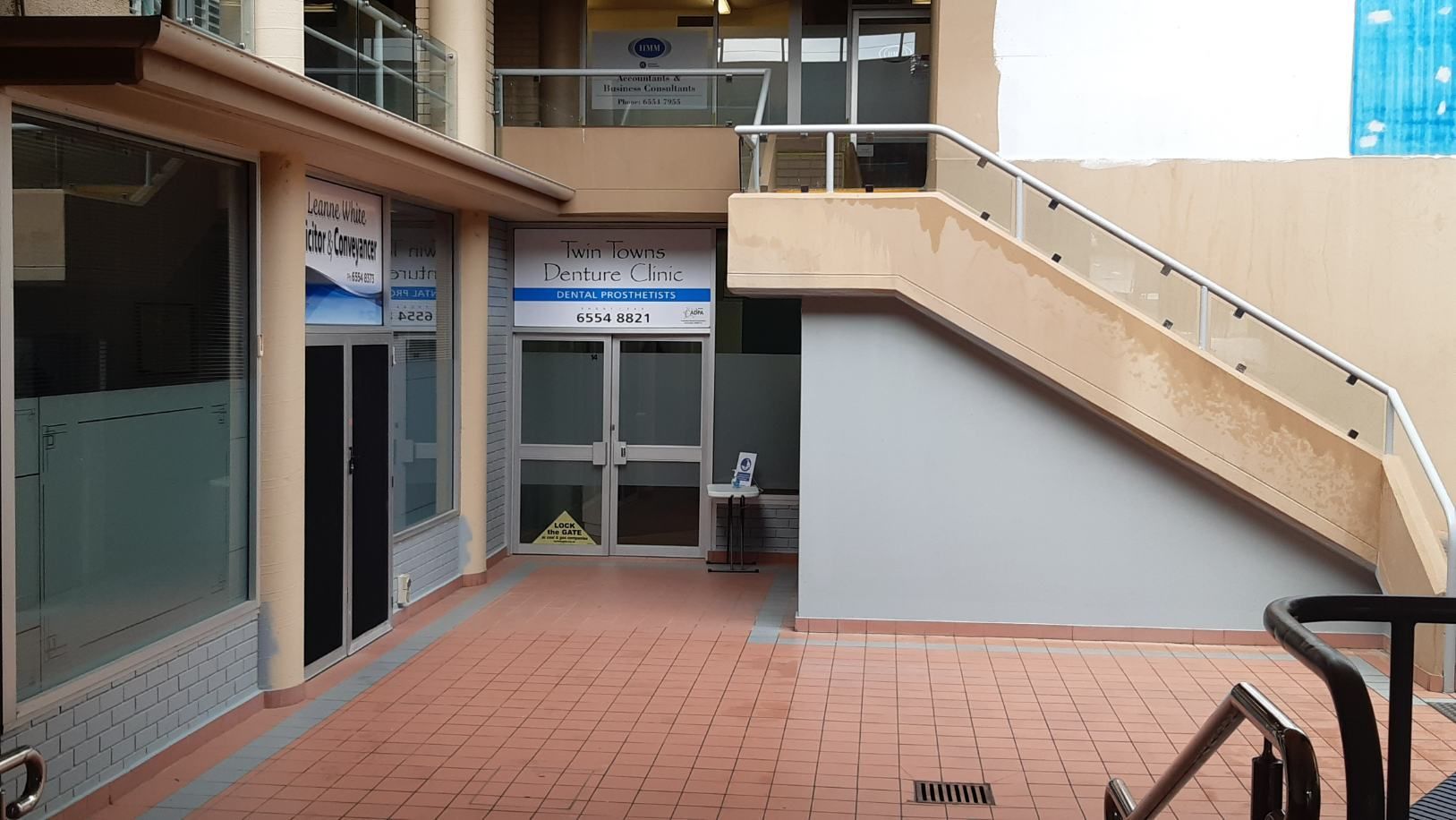 A Building With Stairs Leading Up to the Second Floor — Twin Towns Denture Clinic In Forster, NSW