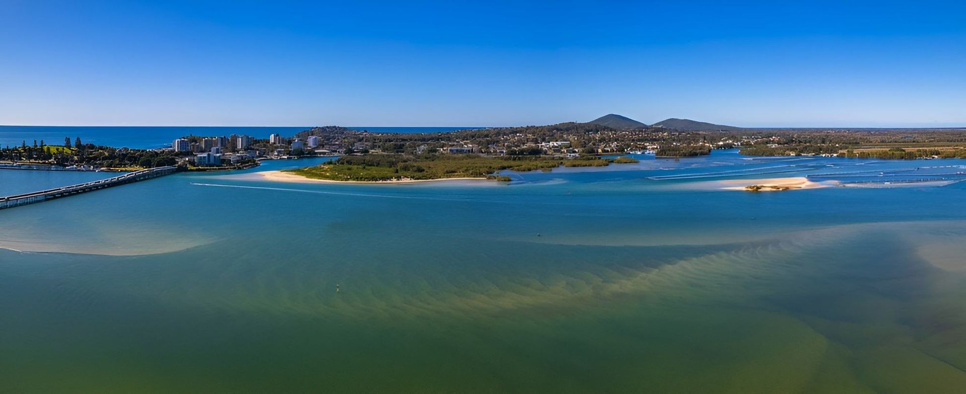 An Aerial View of a Body of Water With a City in the Background — Twin Towns Denture Clinic In Tuncurry, NSW