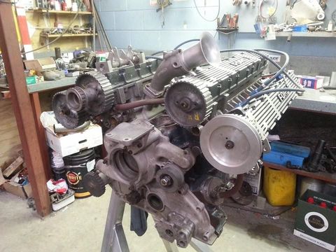 A large engine is being worked on in a garage. A large engine is being worked on in a garage.