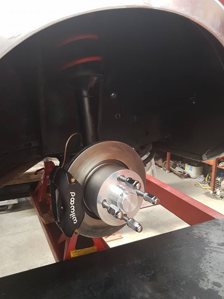 A close up of a brake disc on a car.