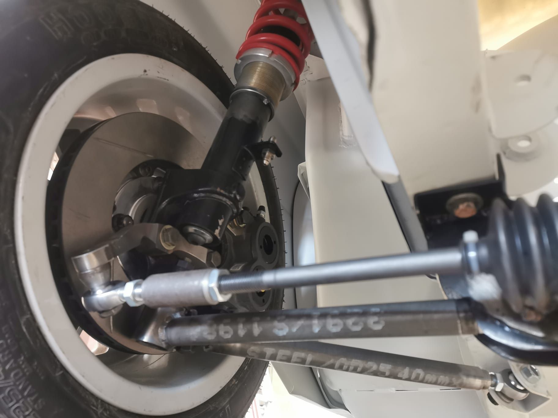A close up of the underside of a car suspension system.