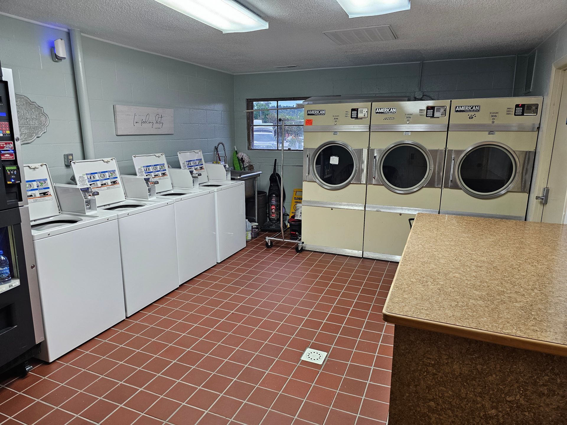 A laundromat with a lot of washers and dryers