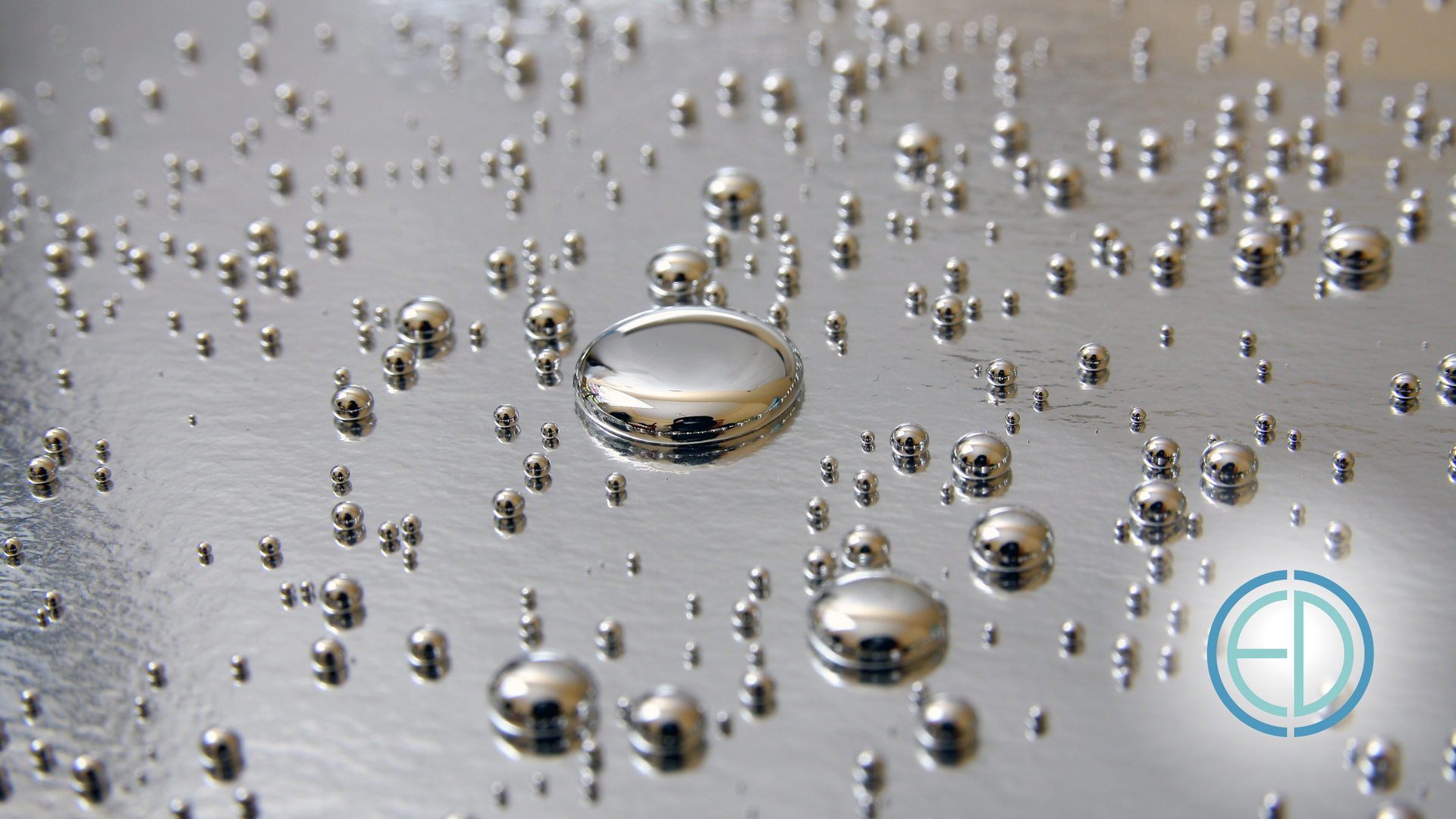 A close up of a metal surface with bubbles and a ed logo