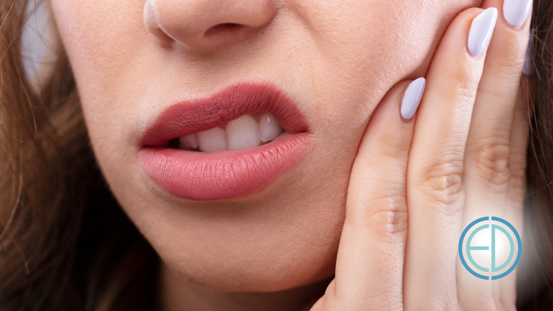 A woman is holding her face in pain because of a toothache.