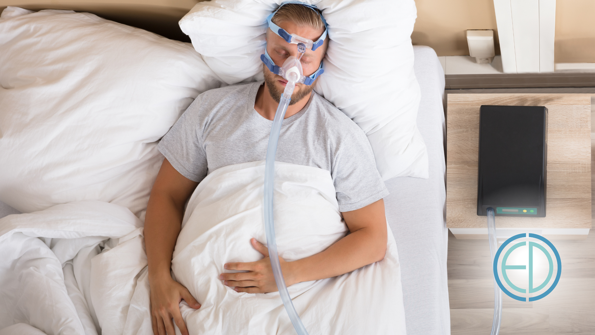Man sleeping in bed with a CPAP machine on his face.