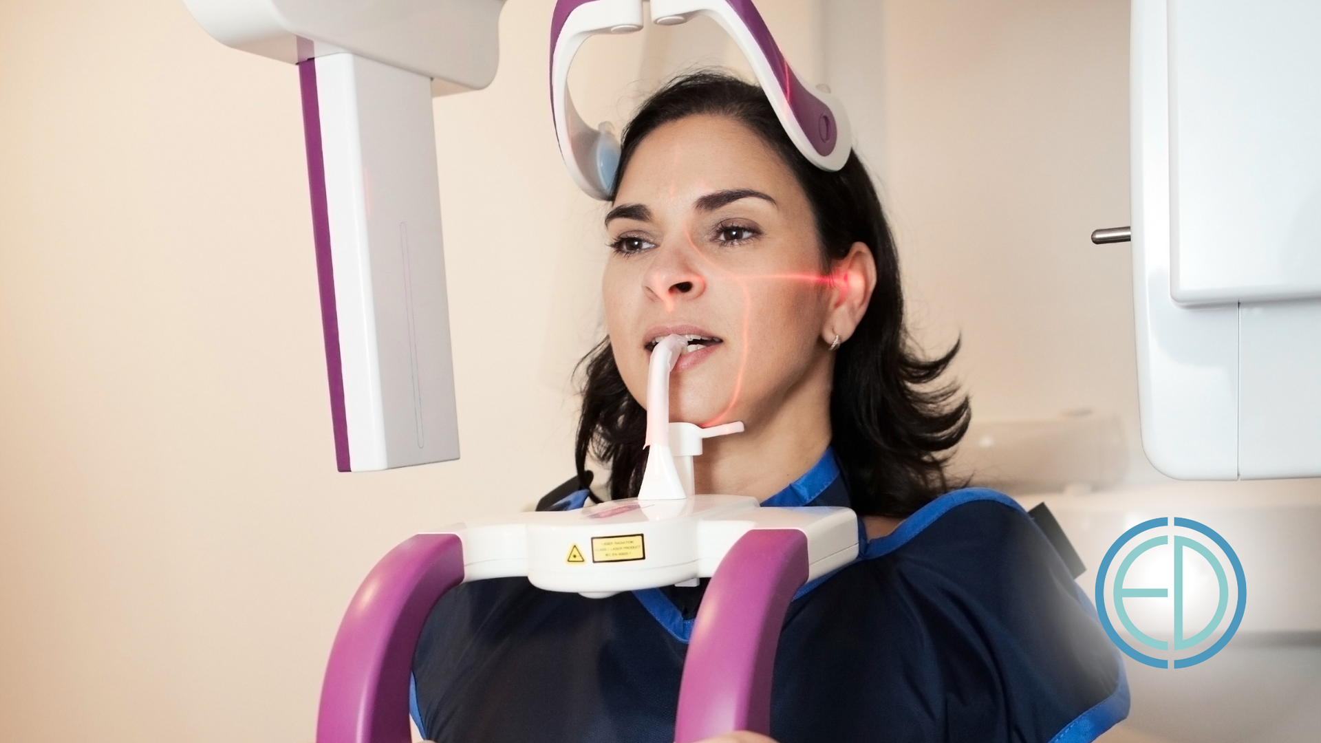 A woman is getting an x-ray of her teeth in a dental office.