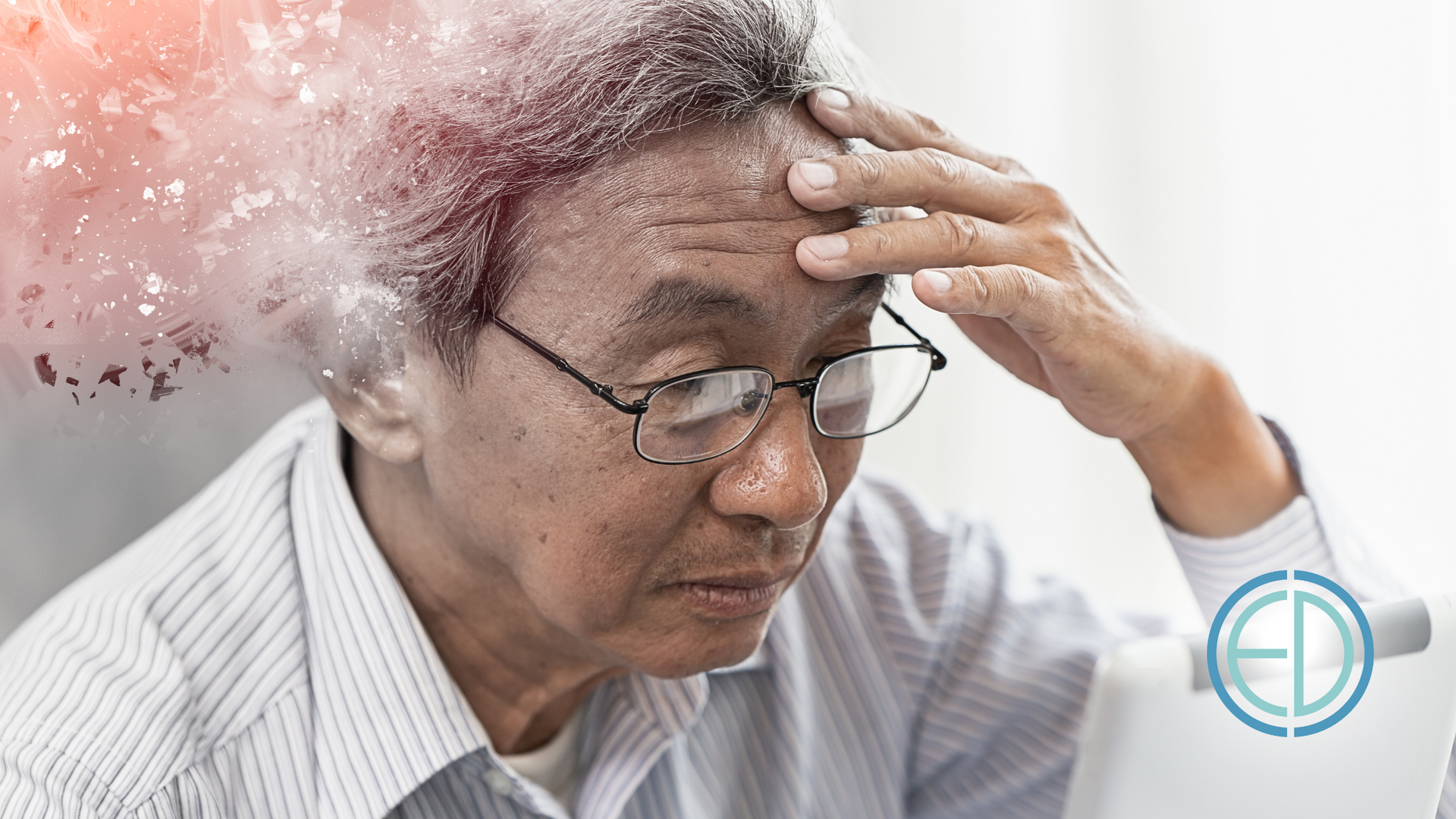 An elderly man with glasses is holding his head in pain.
