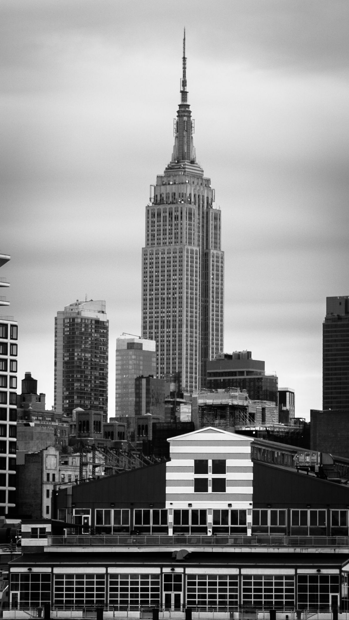 Black-and-white skyline with the Empire State Building centered above city rooftops — Las Vegas architectural photography