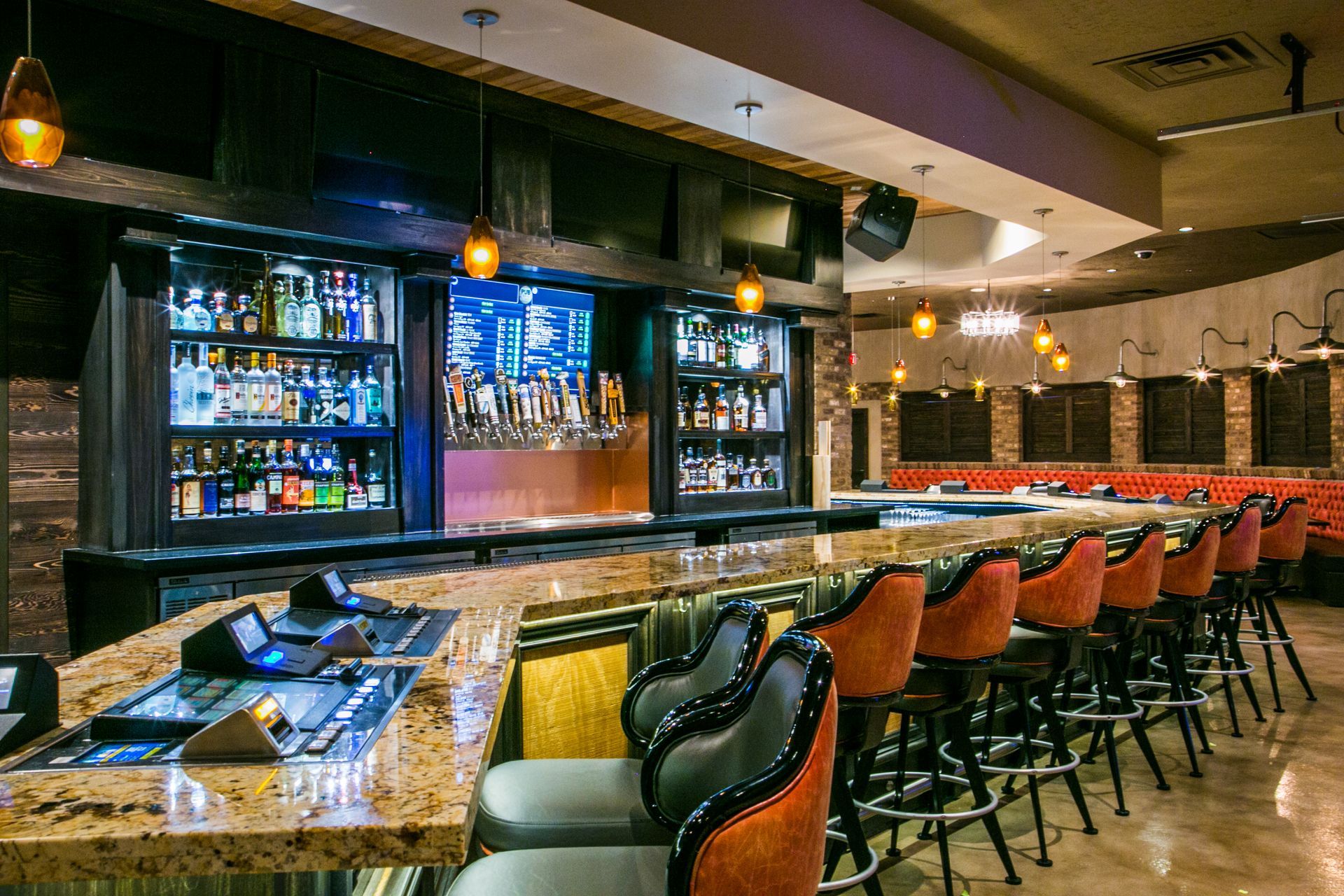 Empty upscale bar with a long counter, orange stools — multi-family photography