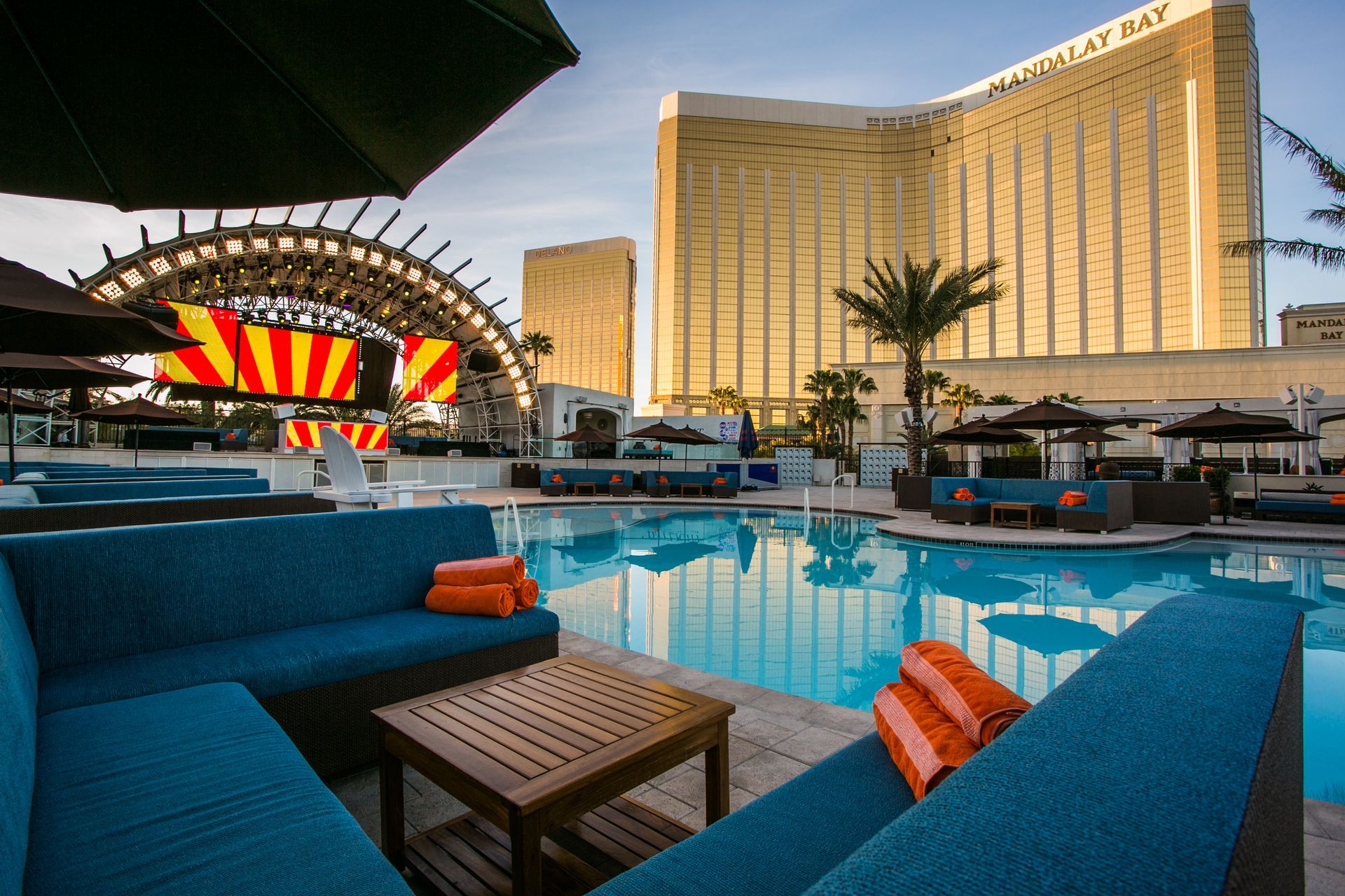 Blue lounge seating by a pool with a striped stage and a tall — Las Vegas multi-family photography