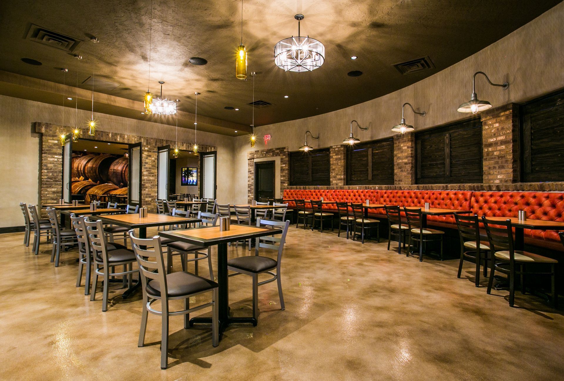 Empty rustic restaurant dining room with tables, chairs, chandeliers — multi-family photography
