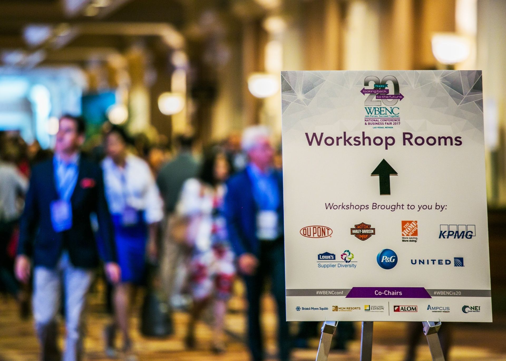 Workshop Rooms sign in a busy hallway, with blurred people walking in the background — Las Vegas professional photography