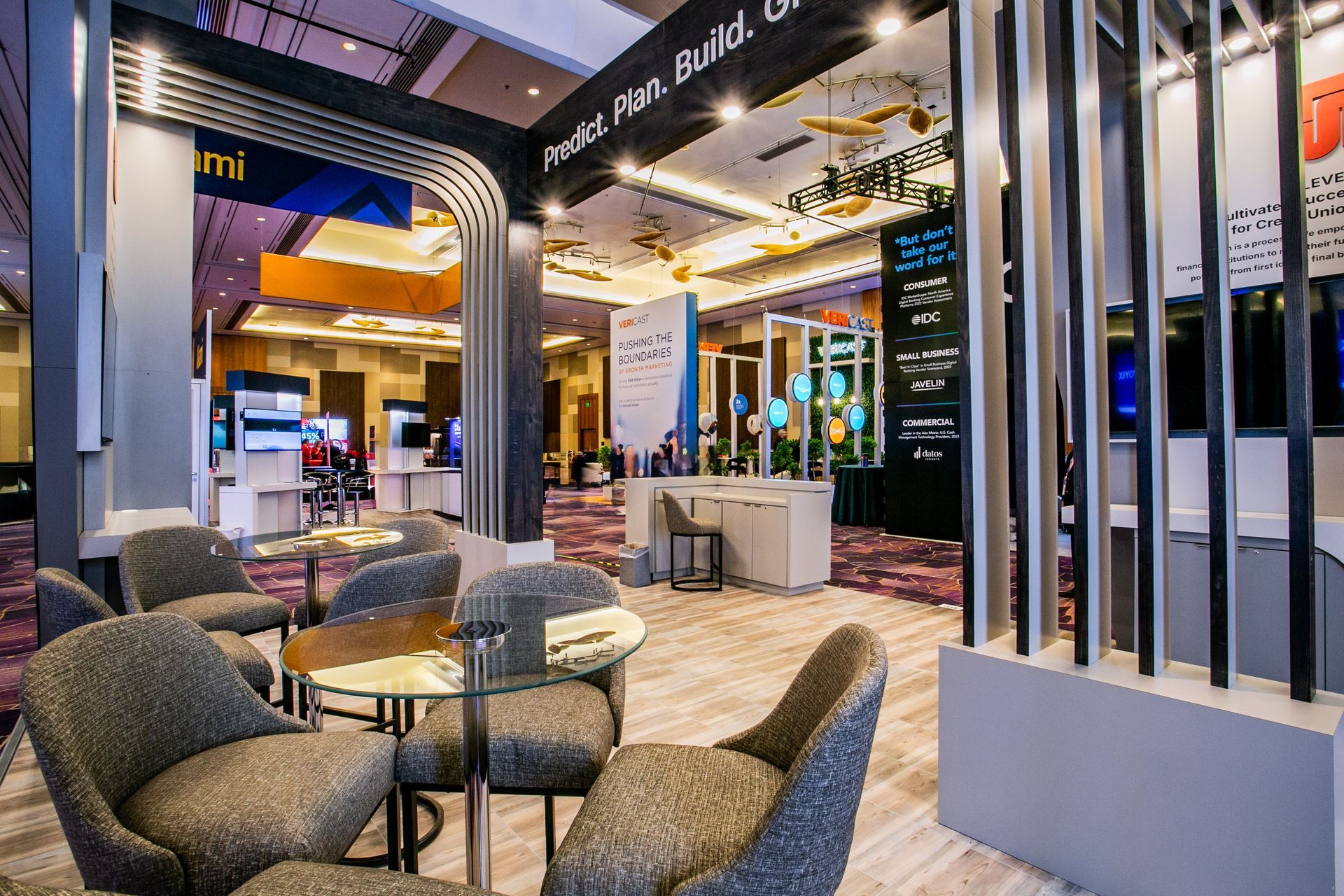 Modern hotel lobby with lounge seating, glass partitions, and warm lighting — convention and event photography