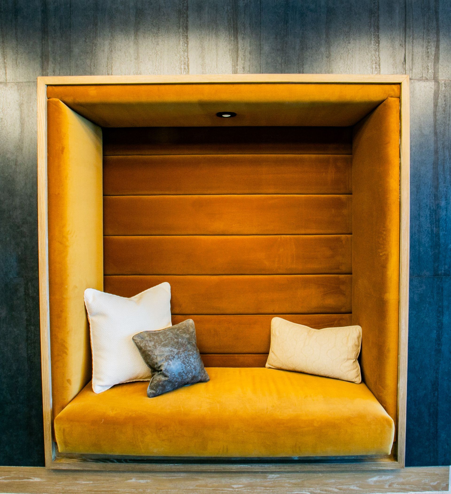 Built-in orange alcove seating with white and gray pillows — Las Vegas multi-family photography