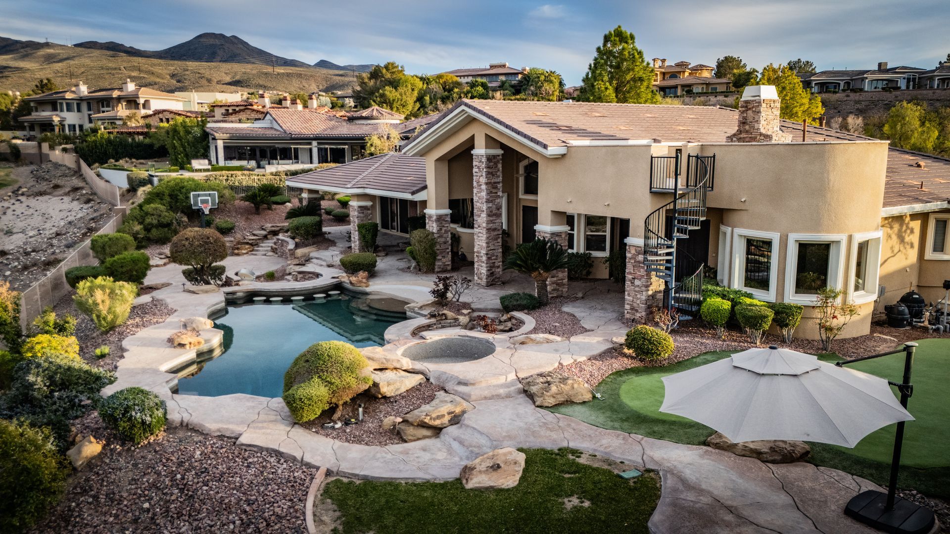 Modern house with desert landscaping, a small pond — Las Vegas real estate photography