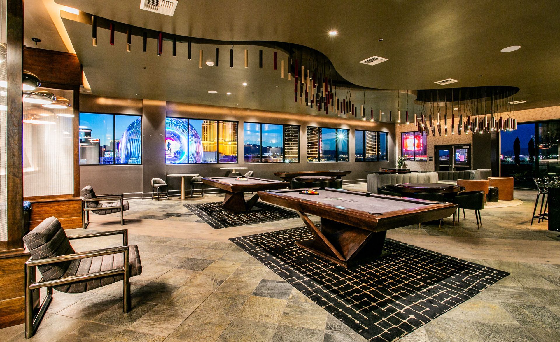 Modern lounge with low tables, patterned rugs — multi-family photography