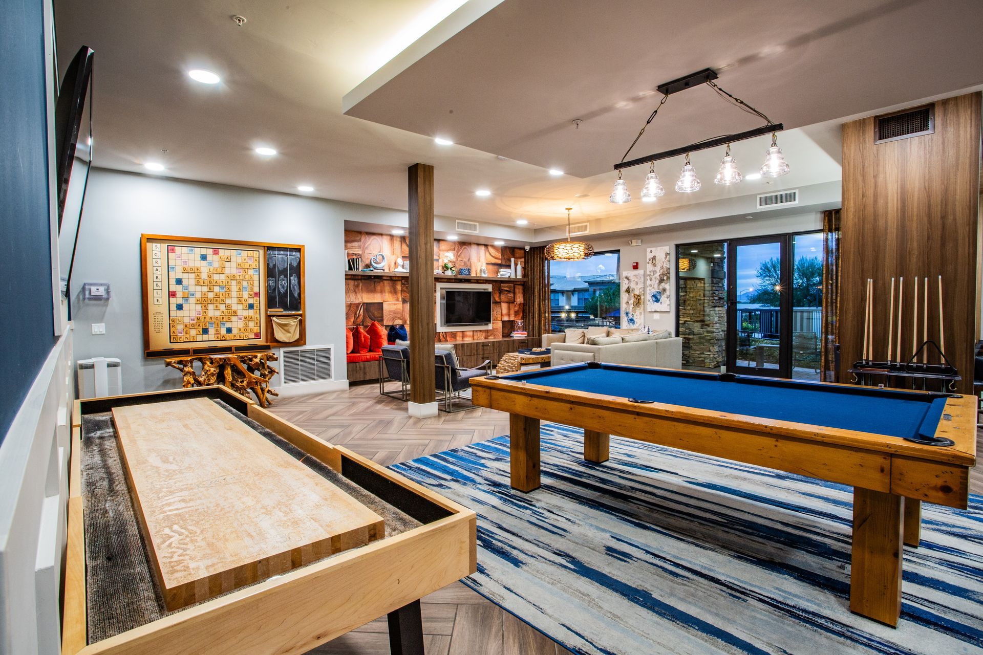 Modern game room with shuffleboard, pool table — multi-family photography