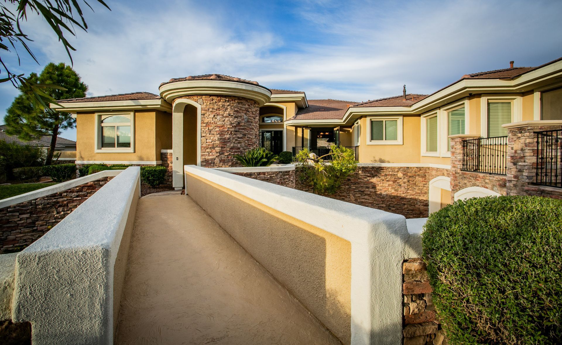 Modern single-story house with tan stucco, stone accents — Las Vegas real estate photography
