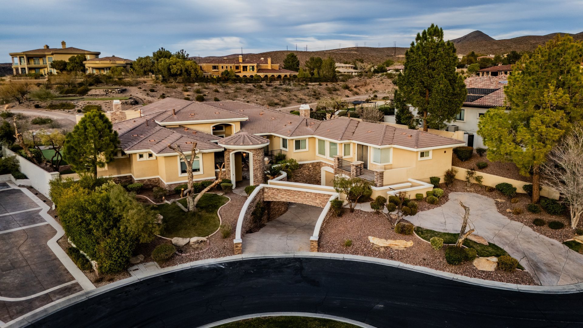 Aerial view of a tan suburban house with desert landscaping and — Las Vegas real estate photography