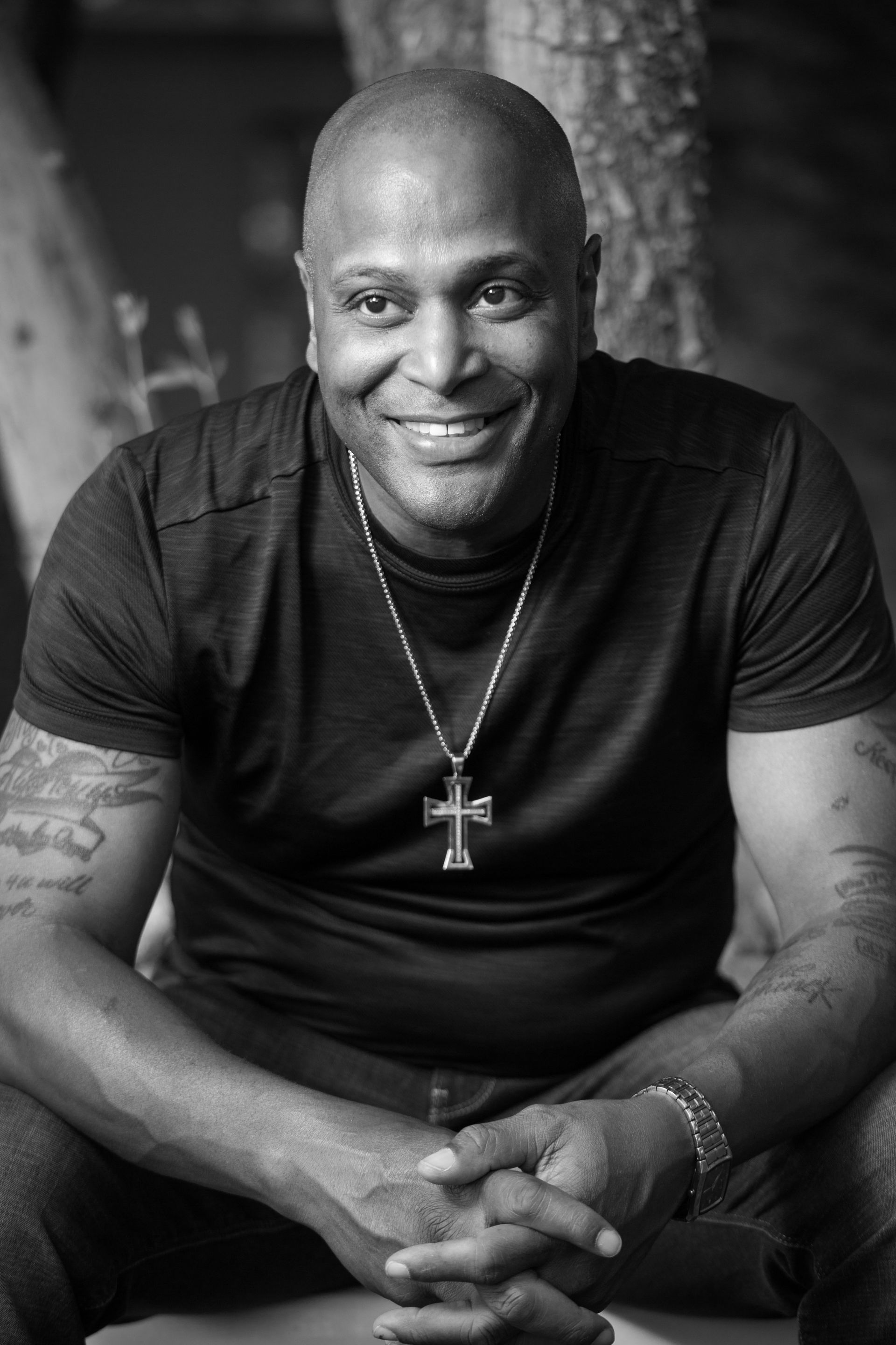 Smiling man seated with folded hands — Las Vegas portrait photography