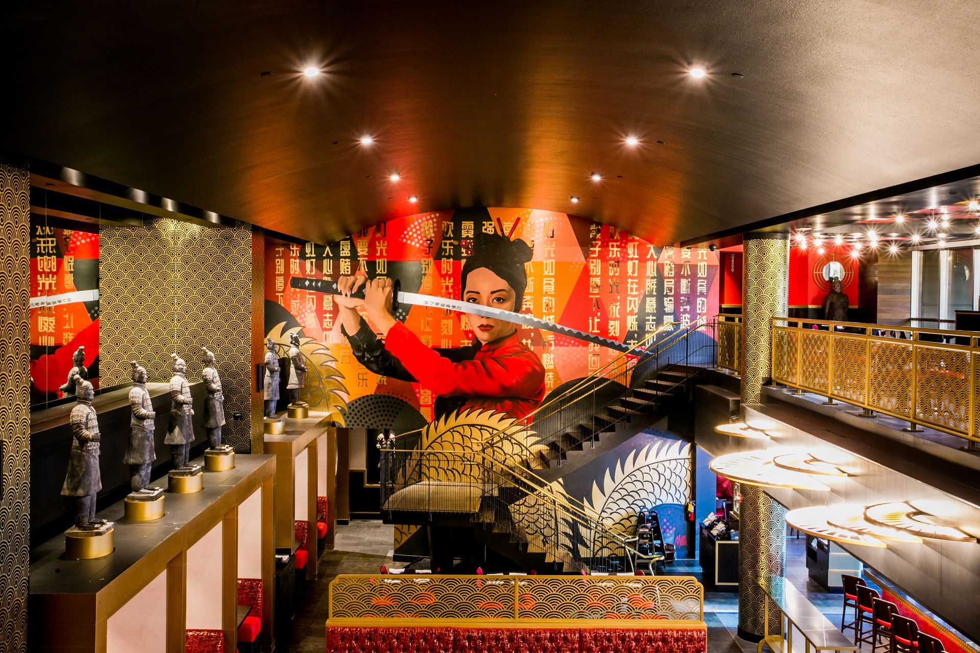 Brightly lit ornate restaurant interior with red decor, patterned walls, and rows of tables and chairs — commercial multi-family property photography