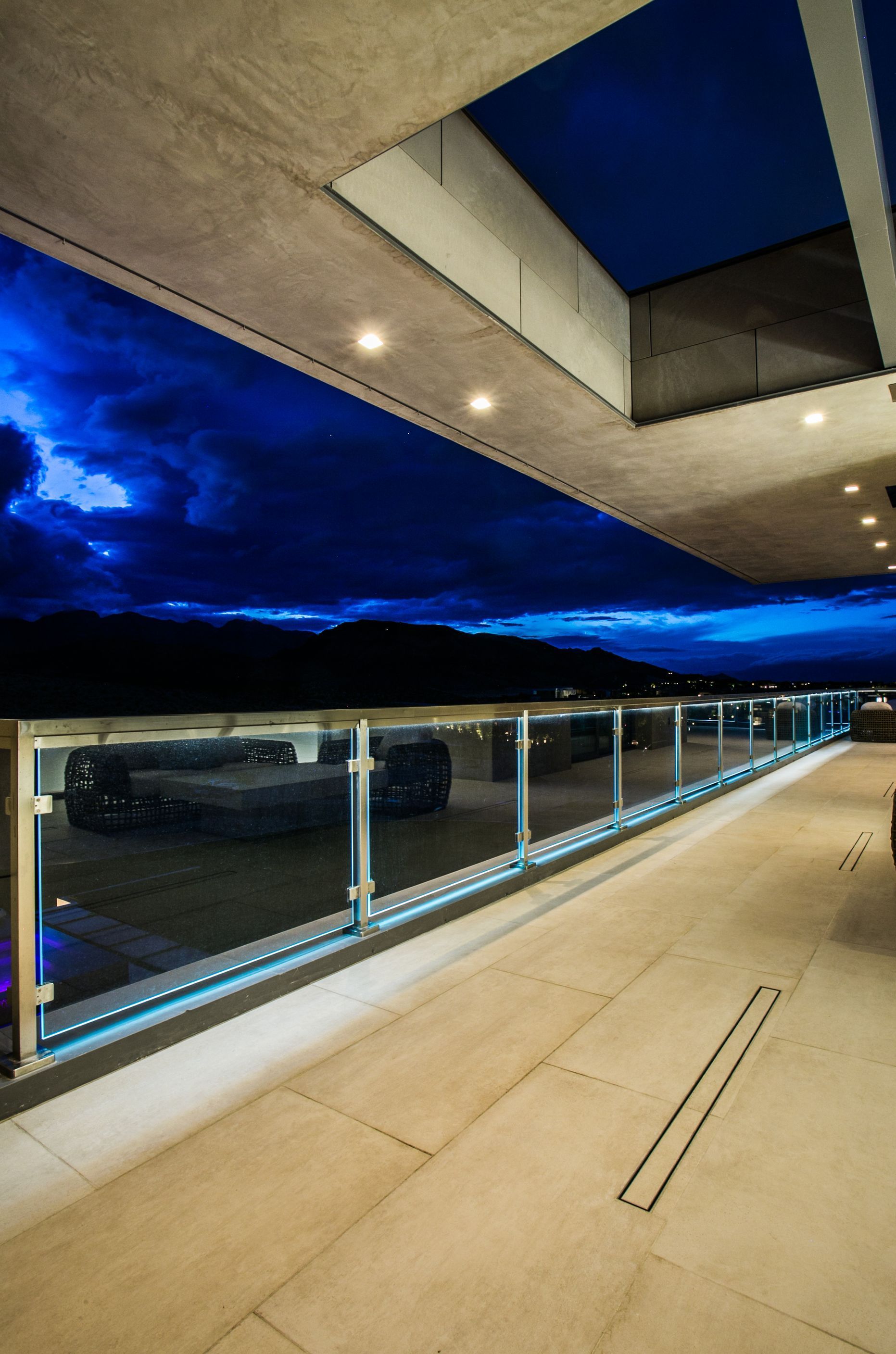 Empty modern balcony overlooking parked cars at dusk — real estate photography