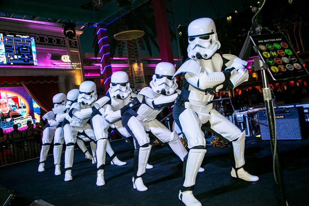 Stormtroopers posing on a neon-lit stage with purple and blue lights — Las Vegas convention and event photography