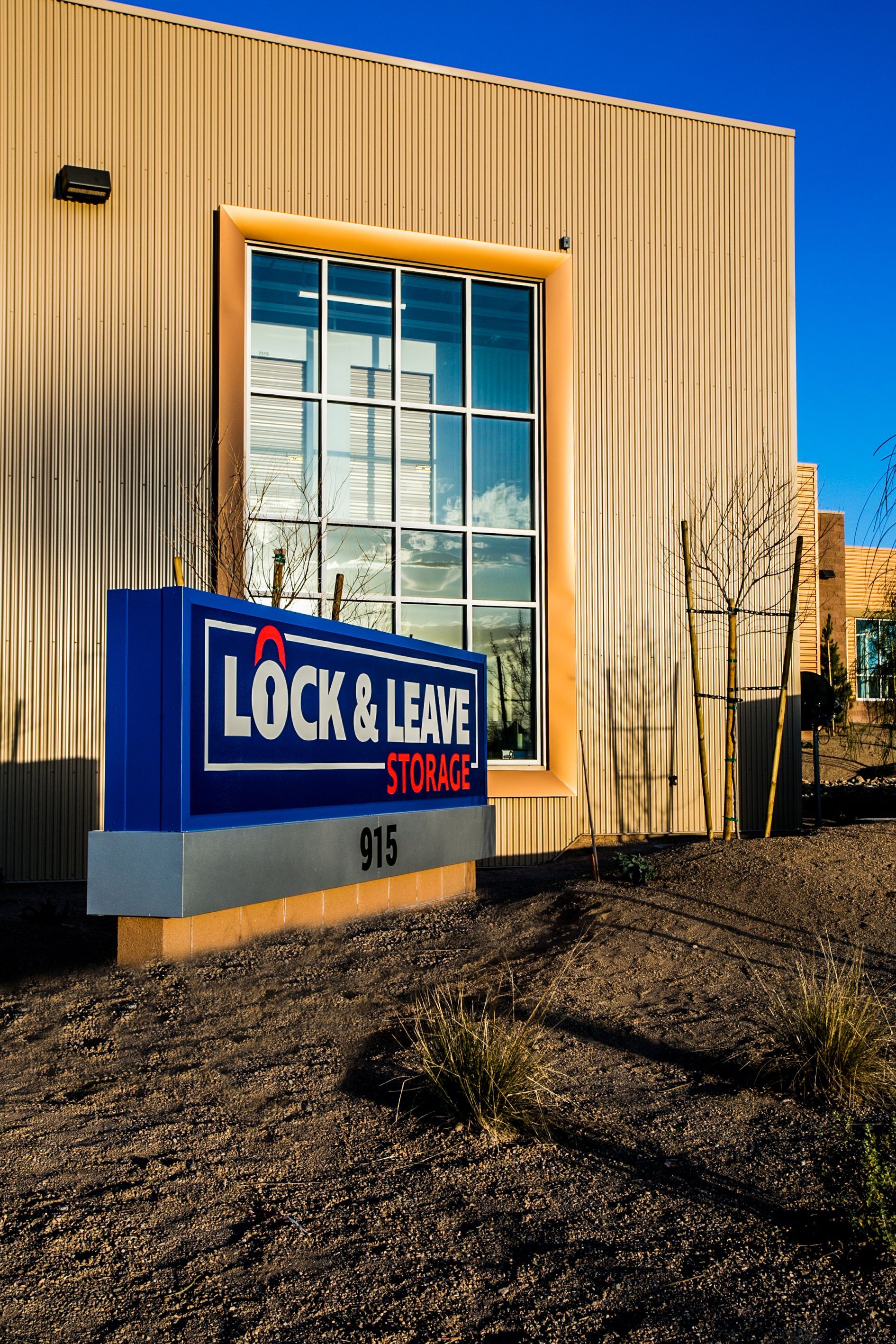 Lock & Leave Storage sign outside a beige building with large windows on a sunny day — Las Vegas commercial multi-family property photography