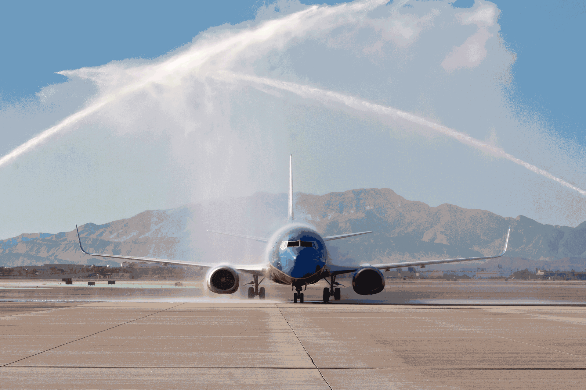 Airplane being sprayed with water arch on runway at airport, front view — Las Vegas professional photography