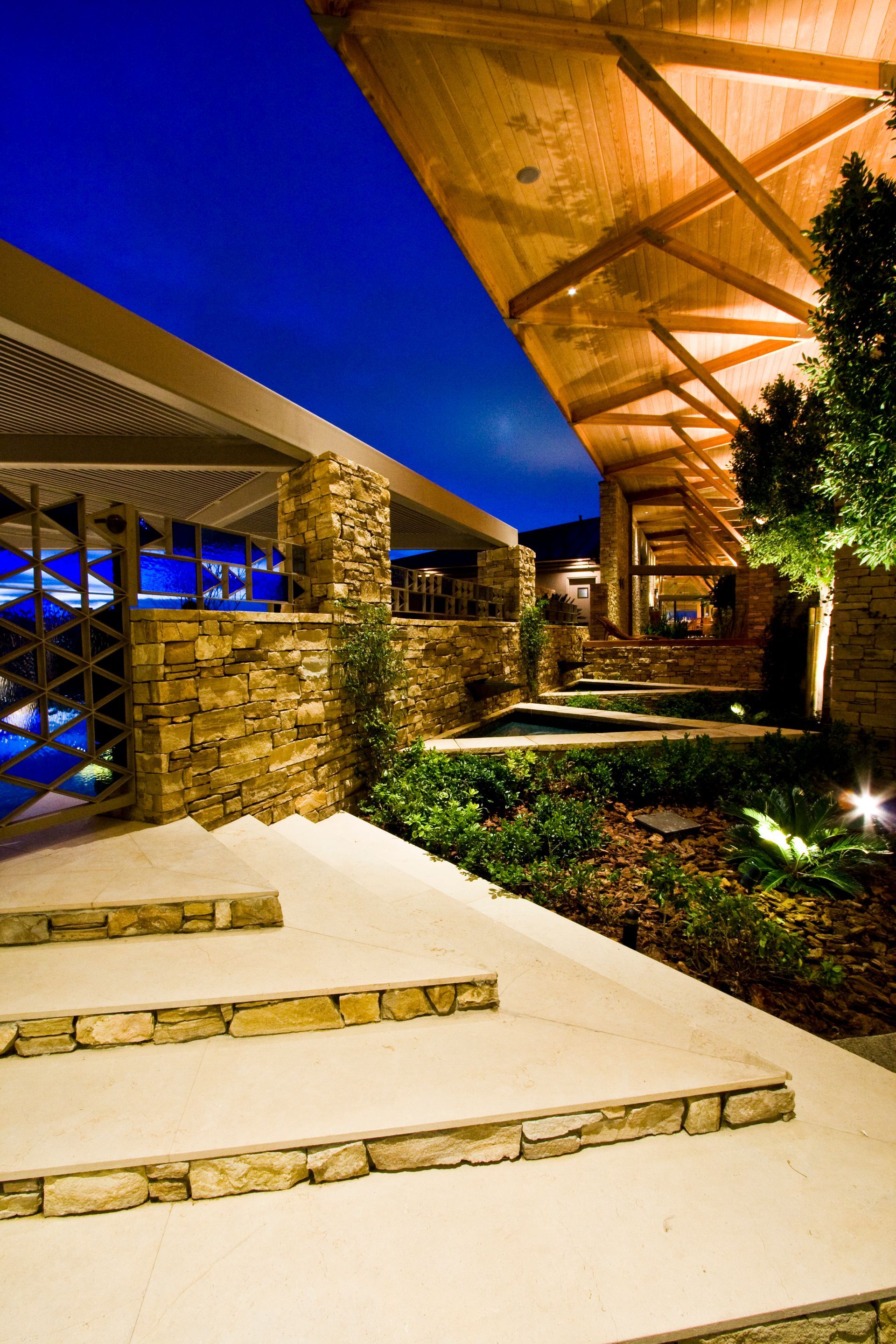 Modern building entrance with stone steps, warm lighting — Las Vegas real estate photography