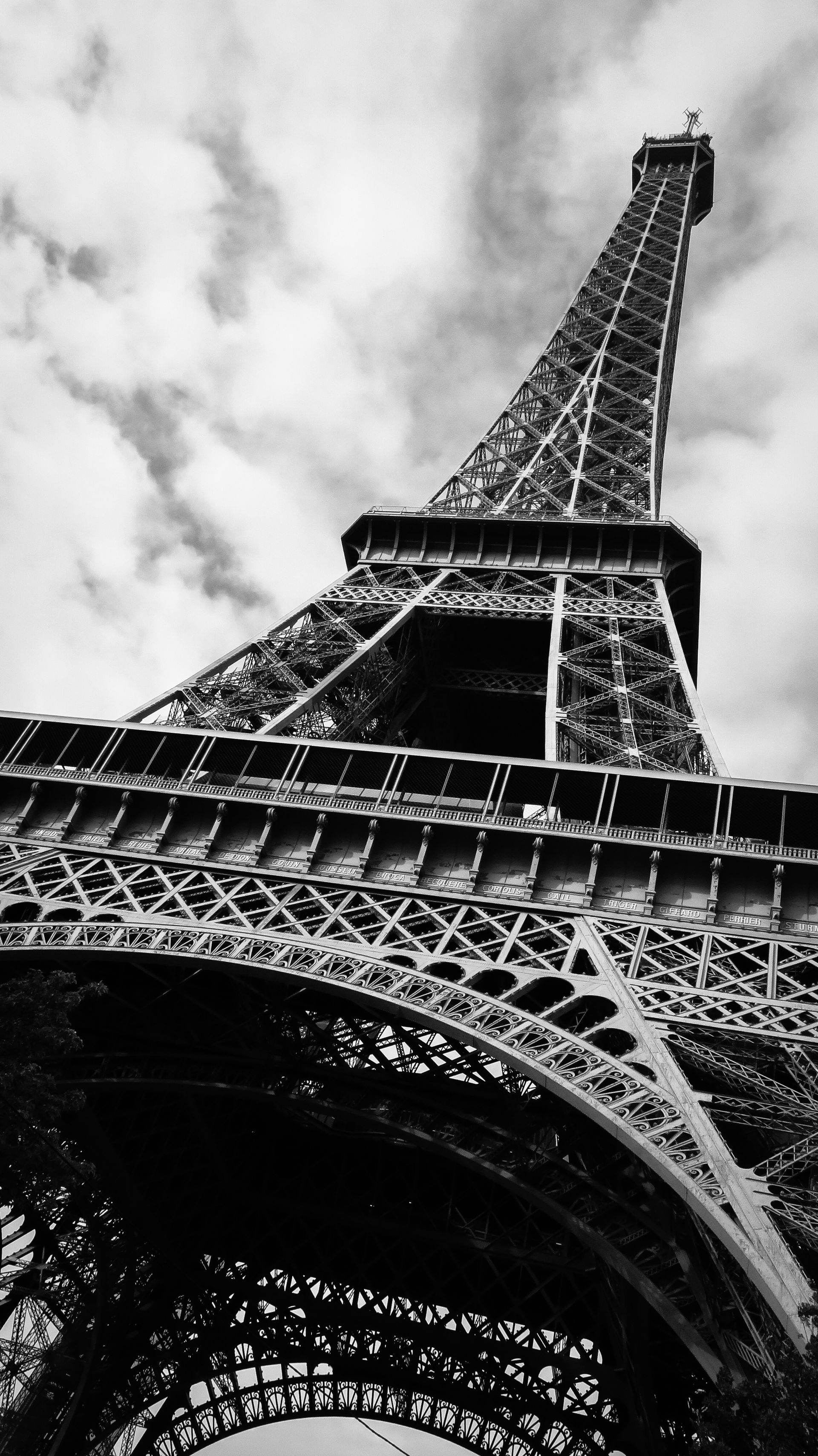 Black-and-white view looking up at the Eiffel Tower against a cloudy sky — Las Vegas architectural photography