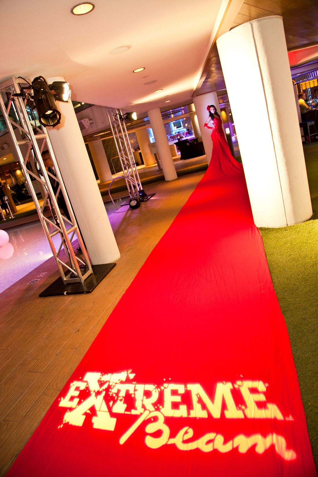 Red carpet in a lit event venue with “Extreme Beam” logo at the entrance — convention and event photography