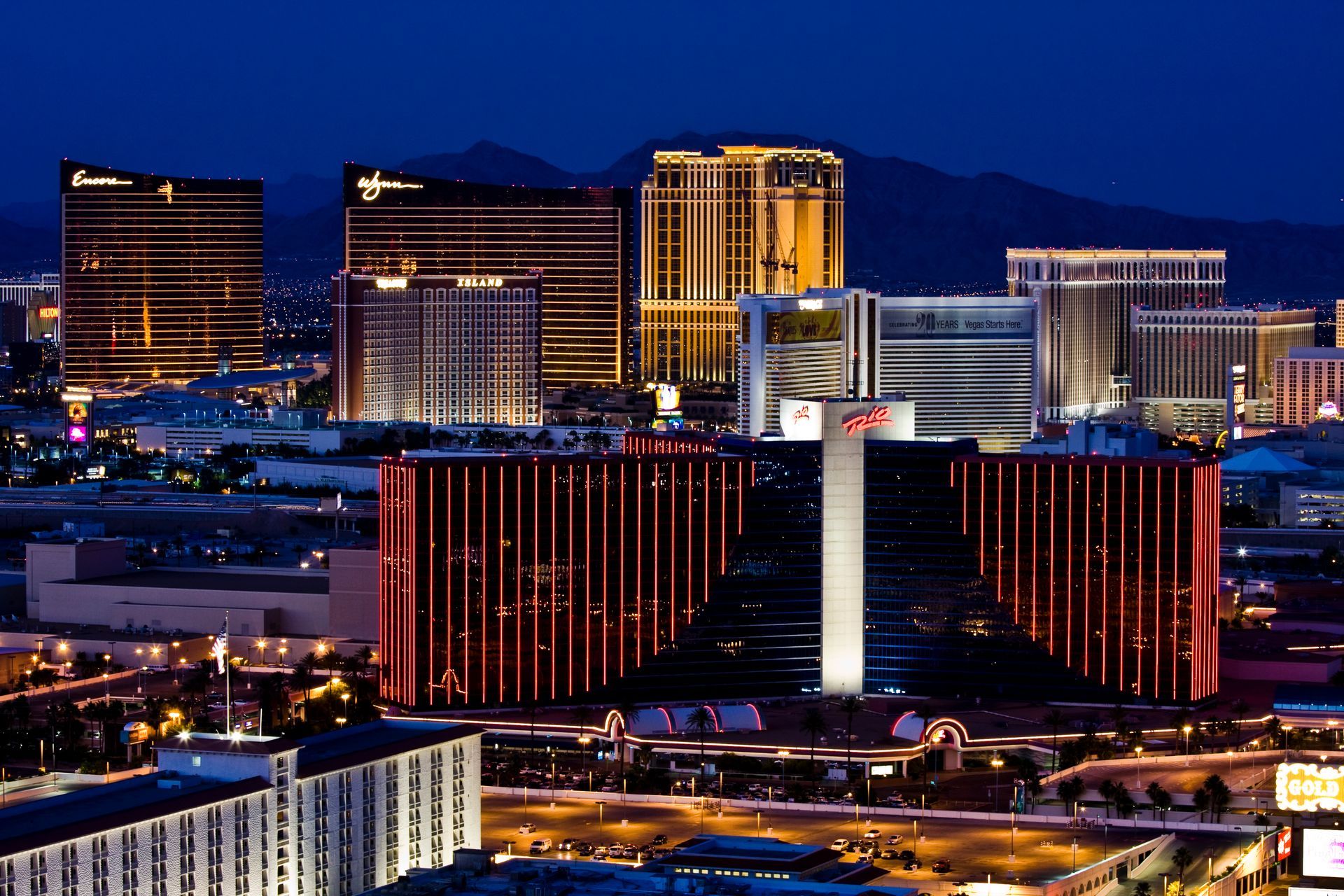 Nighttime city skyline with illuminated hotel towers and casino — multi-family photography