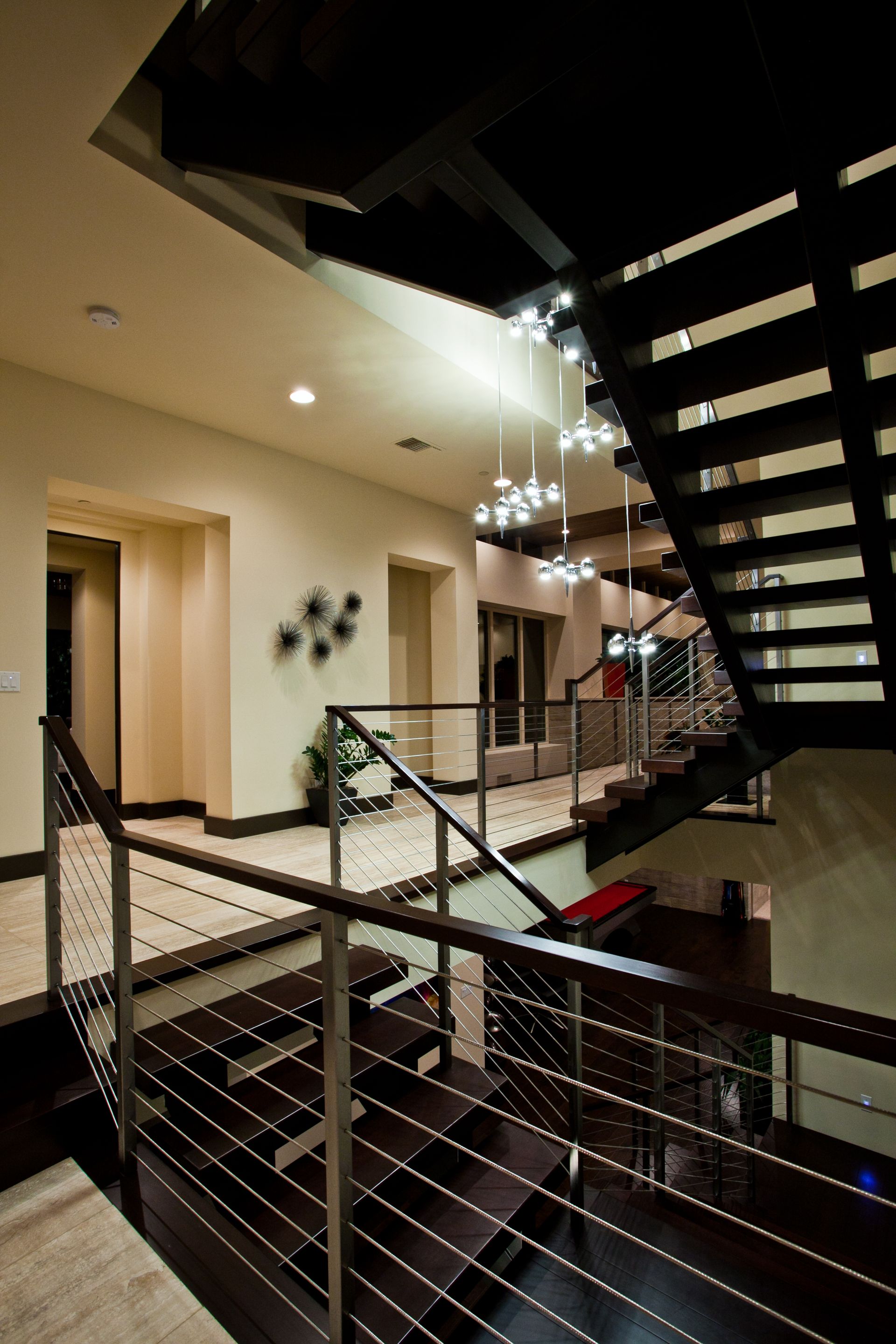 Modern indoor staircase with metal railings and hanging — Las Vegas real estate photography