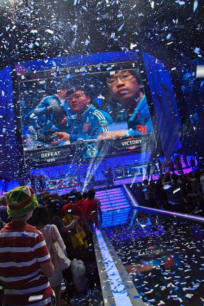 Confetti falls over a stage with a large screen showing two people — Las Vegas event photography