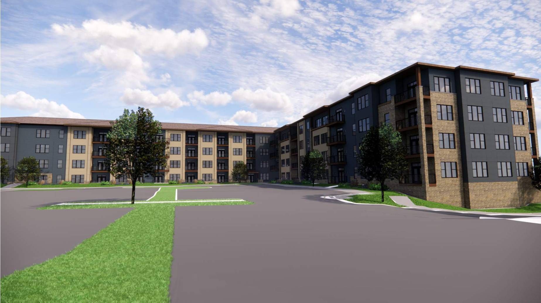 Large apartment building with a parking lot in front of it .