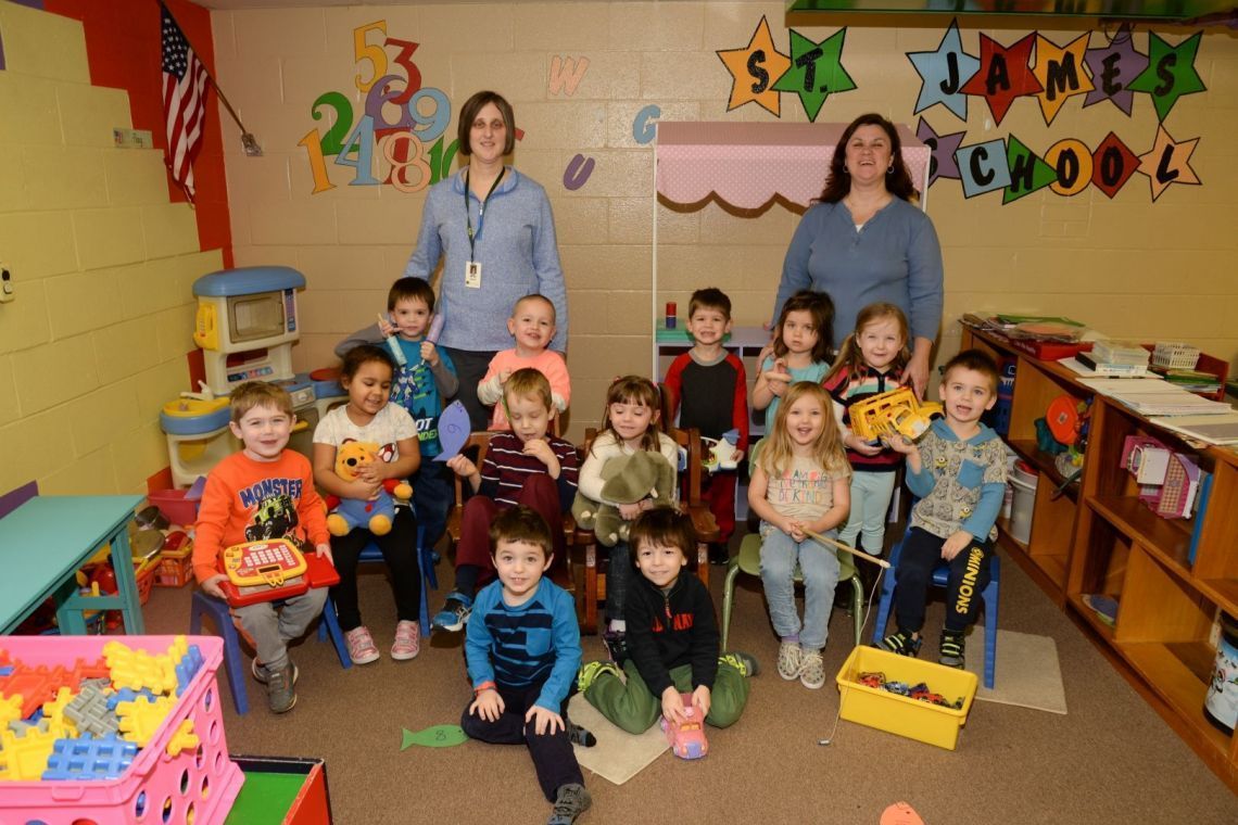 A group of children are posing for a picture in front of a sign that says lame school